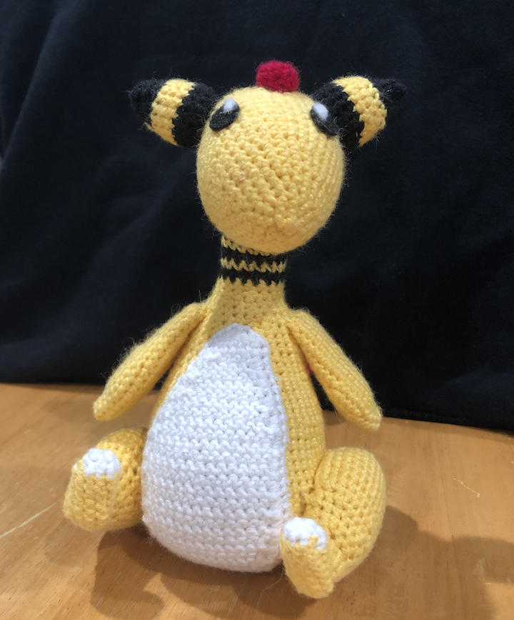 crocheted ampharos sitting and facing you