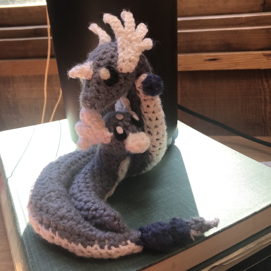 Crocheted dragonair wrapped around a little crochet dratini