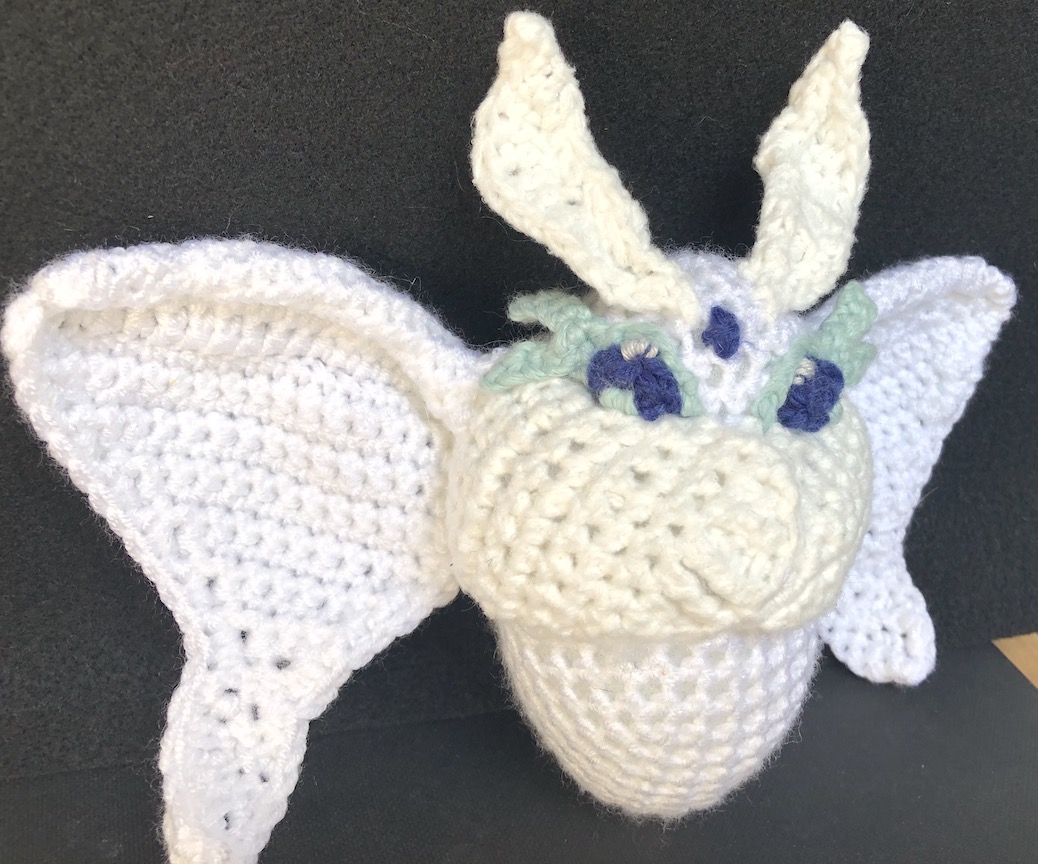 Crocheted frosmoth with fully crocheted eyes and two shades of white for subtle contrast
