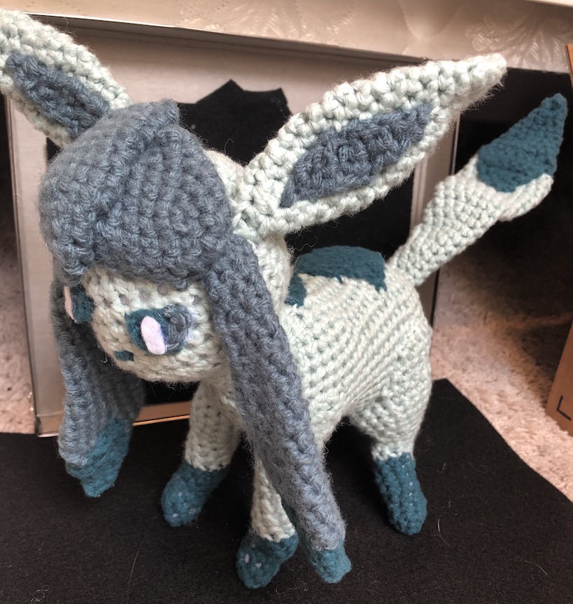 Crocheted glaceon at an angle in a slightly more subdued color palette