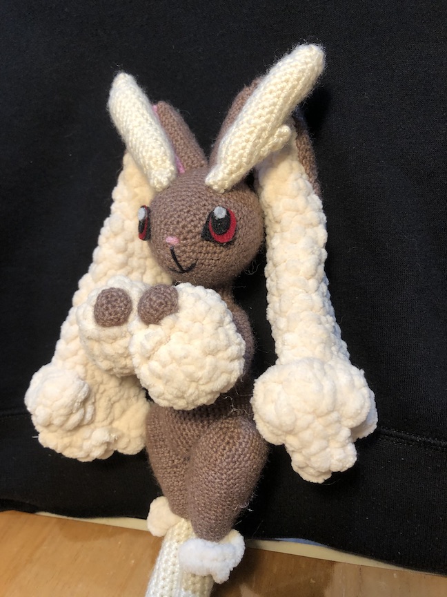 crocheted lopunny doing her classic pose with arms up in front of her