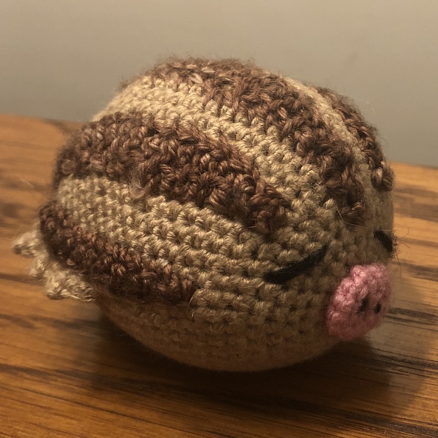 Larger crocheted swinub with smaller yarn facing at an angle