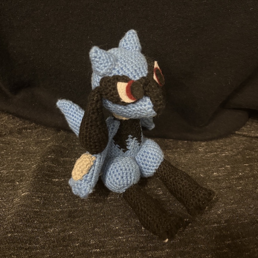 Crocheted riolu at an angle