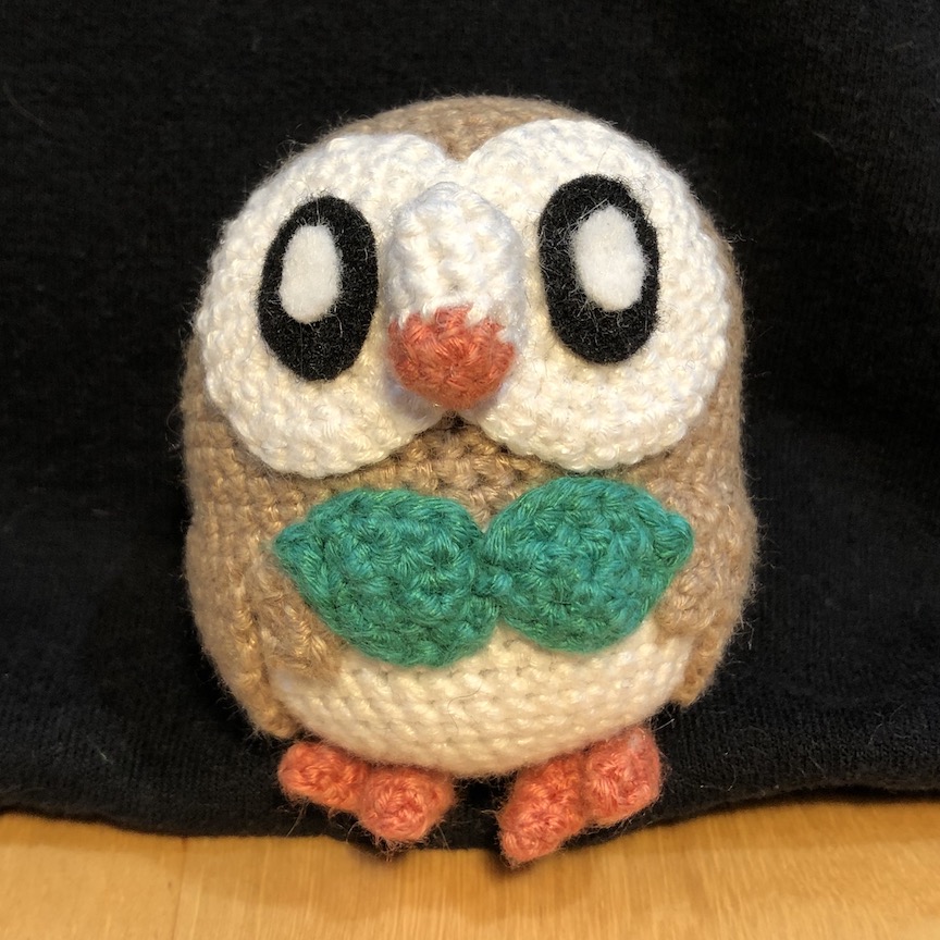 Crocheted rowlet faces forward with large felt eyes
