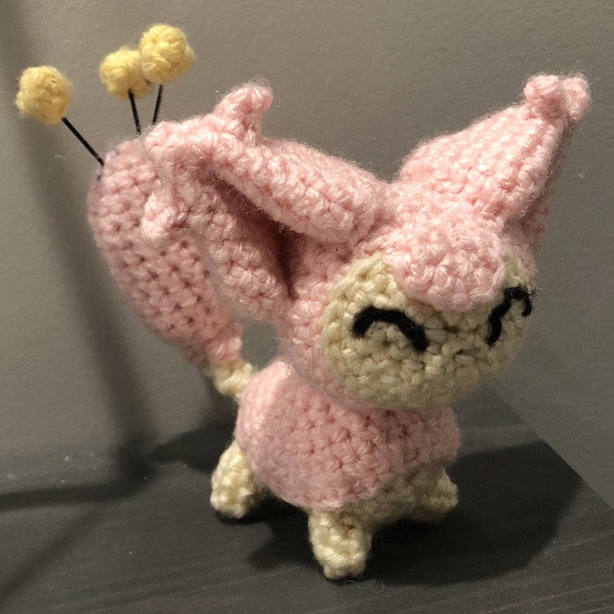 crocheted skitty at an angle