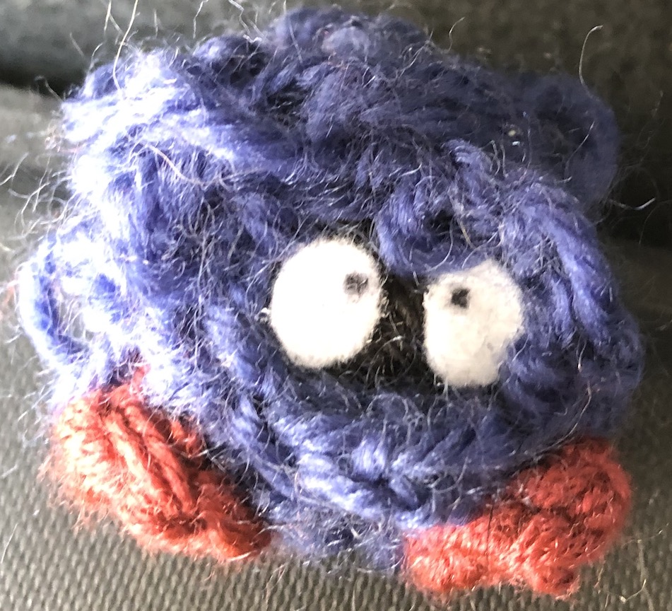 tangela that is partially crocheted and partially yarn ball