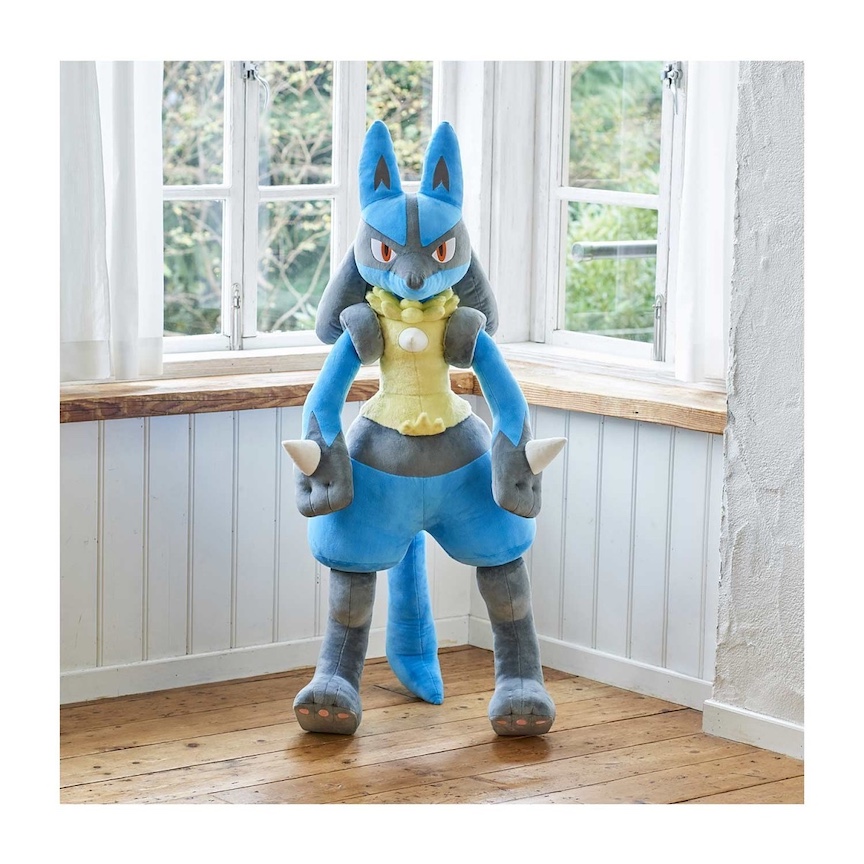 4 foot tall Lucario plushie standing in front of some windows