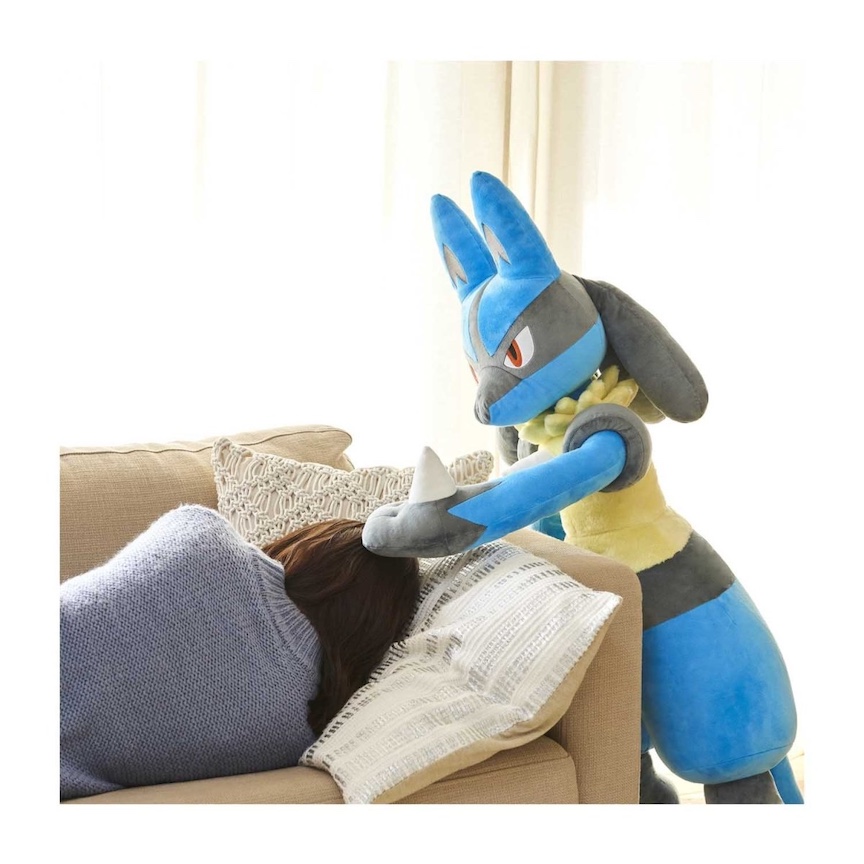 Big Lucario pats the head of a woman sleeping on a couch