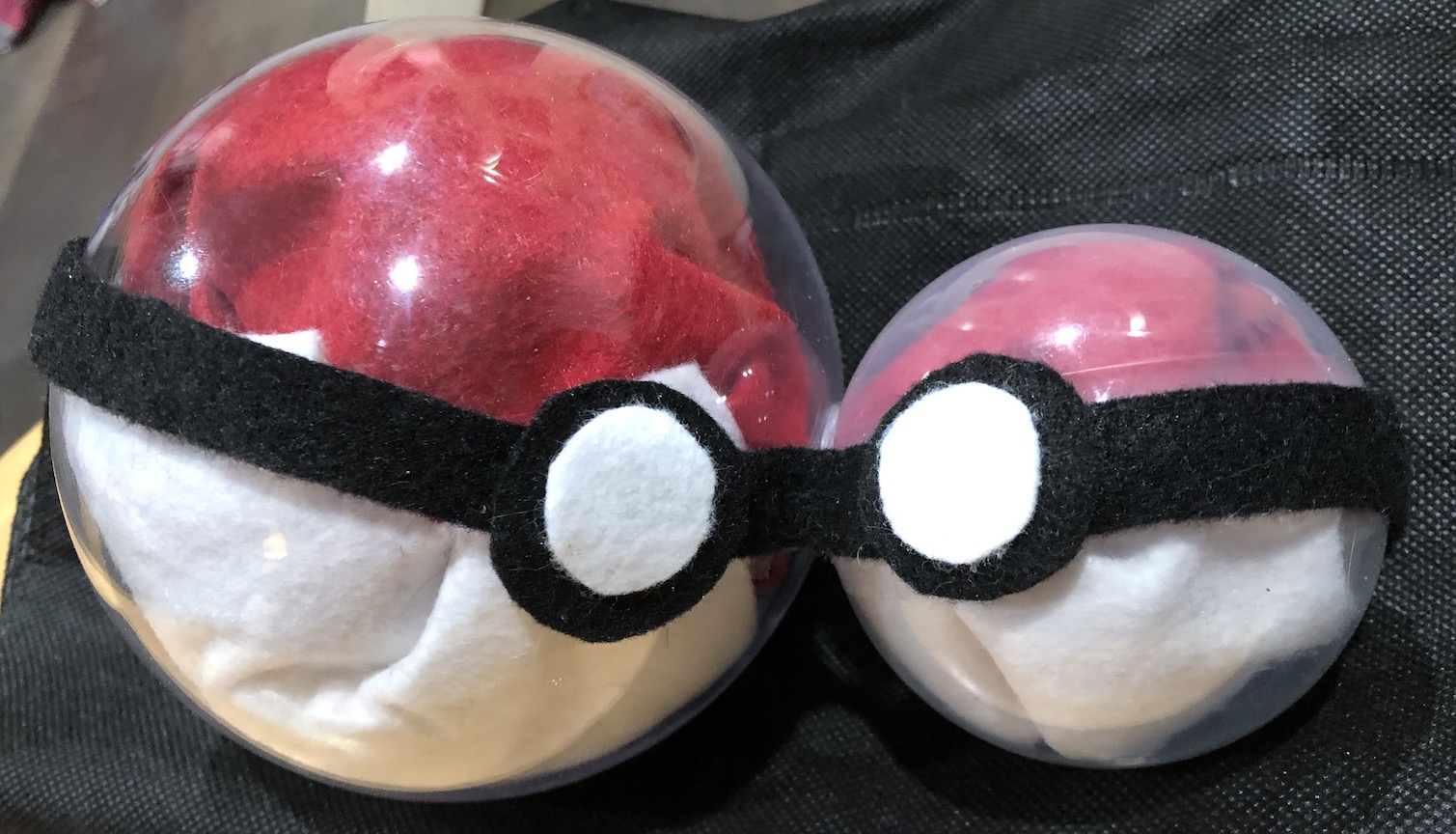 One larger pokéball with a smaller one protruding from the top