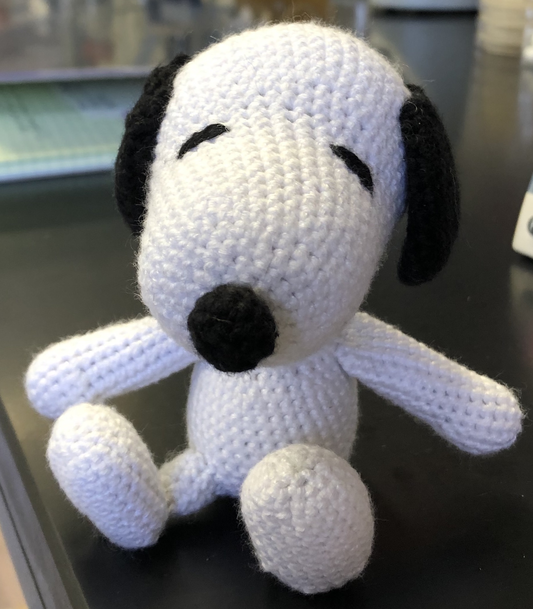 Crochet Snoopy sitting facing you