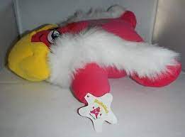 The same Movie Star plush from the side as she lays on her back. Her star-shaped tag is on display with the original Movie Star art from the book on it